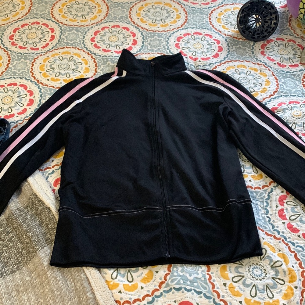 This is a black and pink zip up sweater, it is light and very comfy.